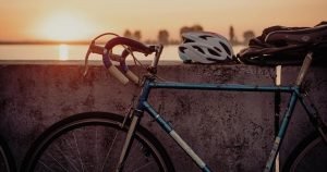 Bicycle safety tips: A steel road bike with a helmet during a sunset
