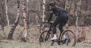 Best Gravel Bikes Under 2000: A woman riding a gravel bike