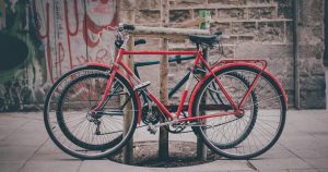 How to Choose a Hybrid Bike? Two hybrid bikes locked to a tree protector