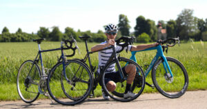 Me kneeling next to 3 different road bikes (from budget to premium).
