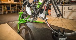 Bike Trainers FAQ: A wheel-on Kinetic bike trainer with a mounted bike in a garage