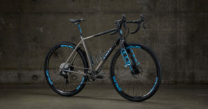 Best Titanium Gravel Bikes: Sage Titanium Gravel Bike shot in front of a concrete wall