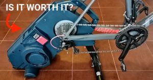 Elite Turno smart trainer with a bike on a tile floor