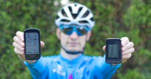 Garmin Edge 1030 Plus vs. Wahoo ELEMNT ROAM: e holding Garmin Edge 1030 Plus and Wahoo ELEMNT ROAM