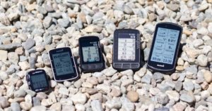How to Choose a Bike Computer: Sigma speedometer, Garmin Edge 520, Wahoo ELEMNT BOLT v2, Wahoo ELEMNT ROAM, and Garmin Edge 1030 Plus in the pebbles