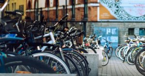 A stack of parked bicycles in a city.