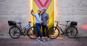 Best Trek Bikes Under 500: Women and man taking a selfie next to two Trek bikes.