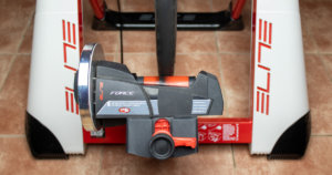 Detail on a wheel-on bike trainer with a mounted bike - tire pressing against the cylinder.
