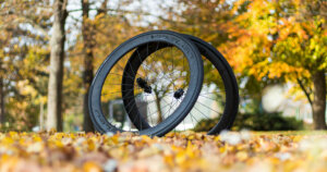 YOELEO SAT PRO 2022 review: Wheels leaned against each other in the park between leaves during autumn.
