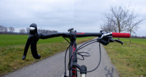 Drop bars vs. flat bars: Left half of the picture shows my road bike with drop handlebar from the front, and the right half of the picture shows my mountain bike with flat handlebars.