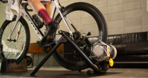 Best fluid bike trainers: A Scott road bike mounted in Saris Fluid2 fluid bike trainer while a cyclist is pedaling.