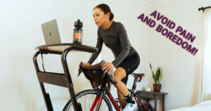 A women riding her road bike indoors in her bedroom.