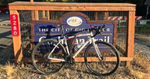 Co-op ADV 2.2 review: ADV 2.2 bicycle in front of the Cushman trail sign.