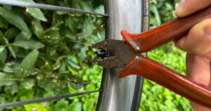 Mistakes when installing tubeless tires: Me demonstrating tightening the valve nut with calipers. Don't do it!