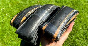 Best tubeless road tires: Me showing a few tubeless road tires (Tufo Comtura 4 TR, Continental Grand Prix GP5000 S TR, Tufo Comtura Prima).