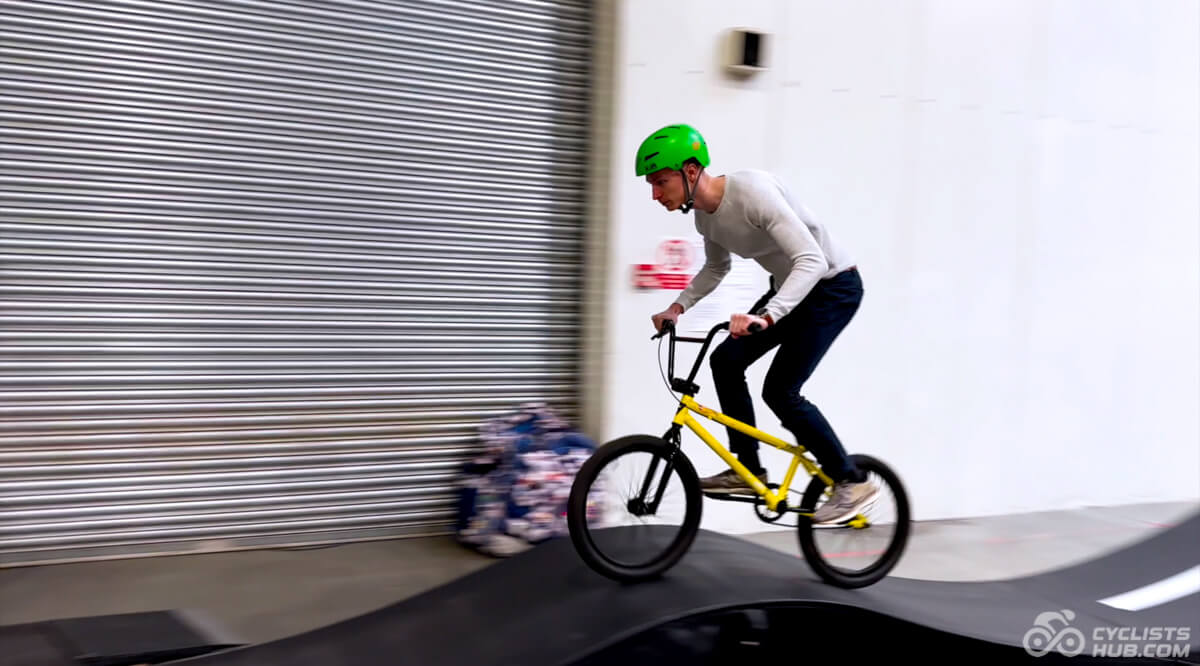 Me riding a BMX on a pump track.
