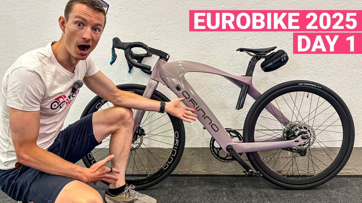 Petr Minarik in front of a super weird e-gravel bike at Eurobike 2025 day 1.