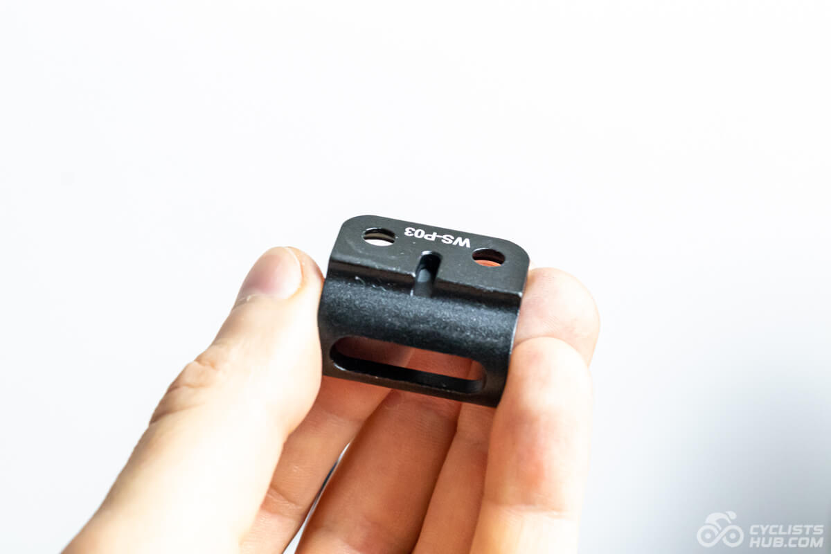 Me holding the Winspace SLC5 front derailleur hanger showing its groove for the Di2 wire.