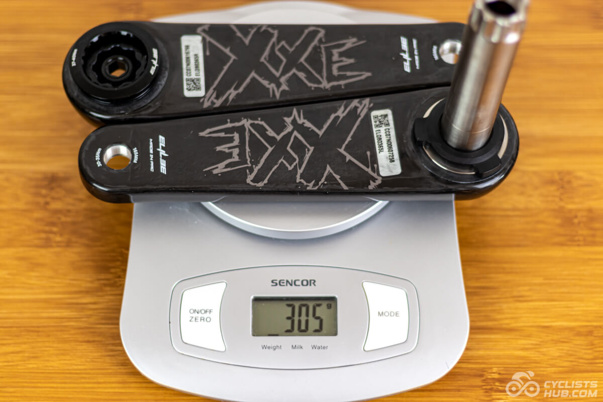 Elilee X310 cranks on a kitchen scale showing the weight of 305g.