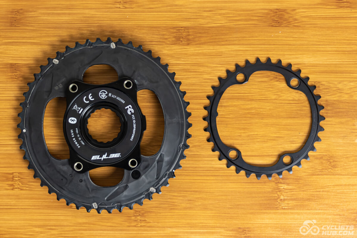 Shimano Ultegra chainrings and Elilee EK01 power meter on a wooden table.
