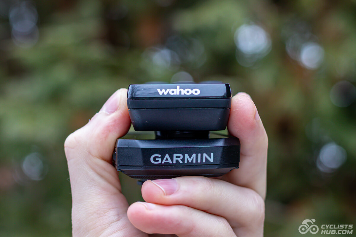 Me holding the Garmin Edge 550 vs. Wahoo ELEMNT BOLT 3 showing the top side.