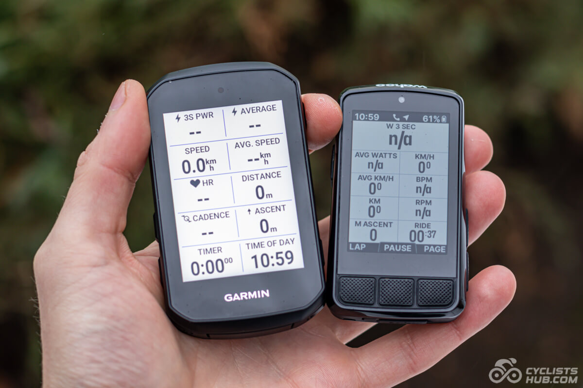 Me holding the Garmin Edge 550 vs. Wahoo ELEMNT BOLT 3 showing their front side.