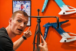Petr Minarik pointing at the new Elilee frameset the Shanghai Bike Show 2026.