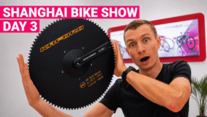 Petr Minarik holding a massive 100T chainring at the Shanghai Bike Show 2026.