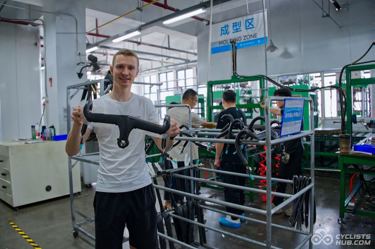 Petr Minařík holding the Winspace HYPER handlebar in the Winspace factory.