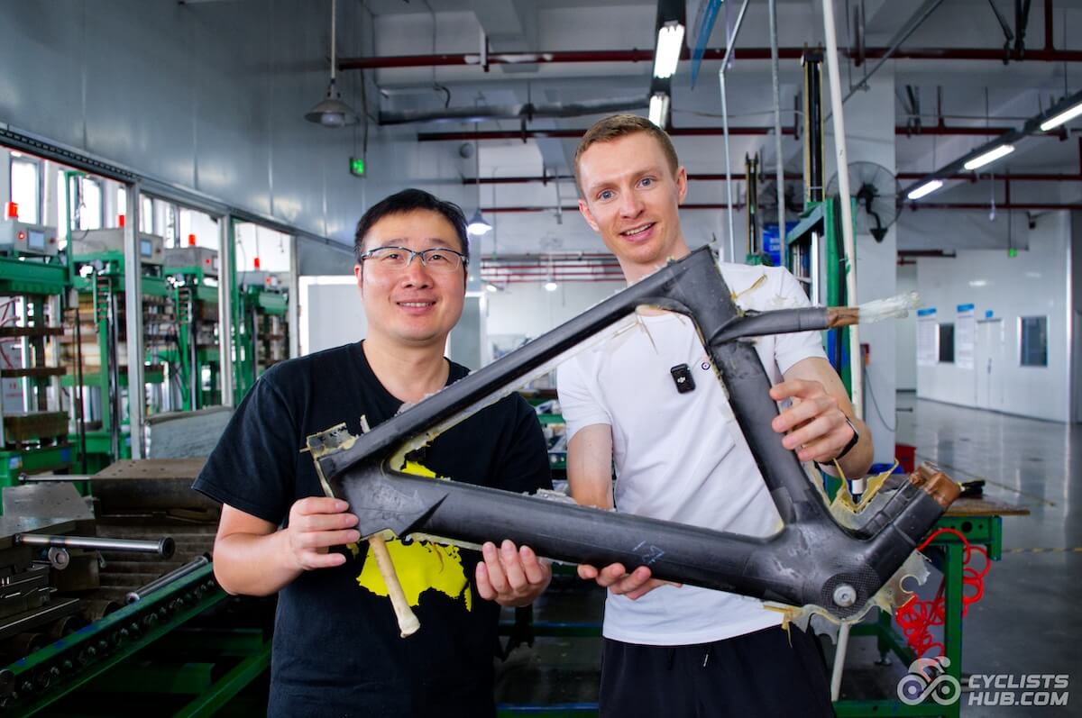 Stephen Cai and Petr Minařík holding a freshly baked Winspace M6 frame in the Winspace factory.