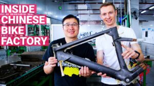 Stephen Cai and Petr Minařík holding a freshly baked Winspace M6 frame in the Winspace factory.