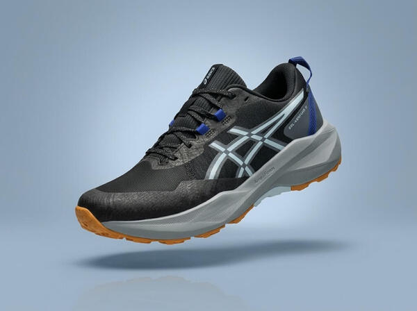 Black ASICS shoes ona blue-ish background.