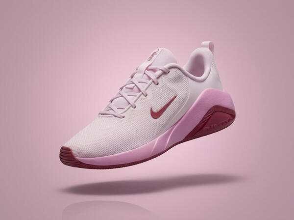 Pink Nike Air Bella on a pink background.