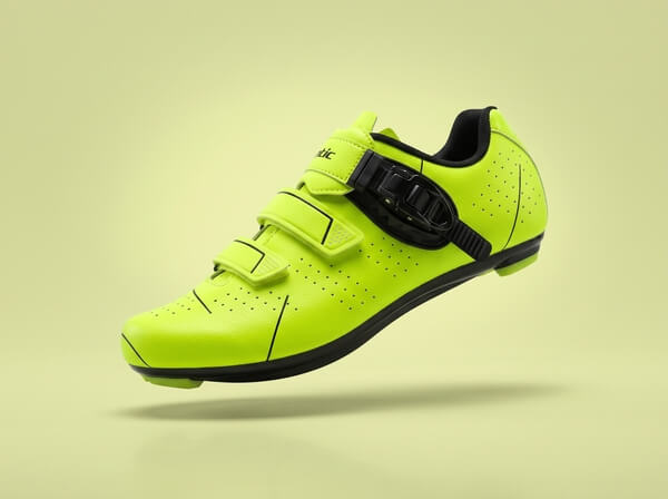 Neon yellow and black Santic road cycling shoe with a ratchet buckle and two Velcro straps, side view.