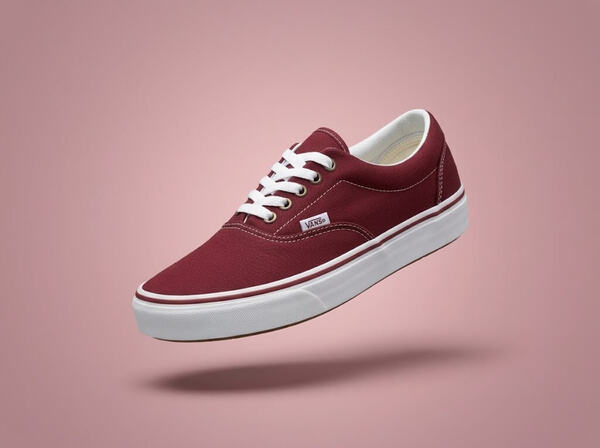 Red Vans Atwood shoes on a red-ish background.